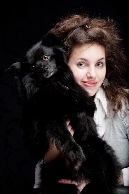 Woman holding black dog