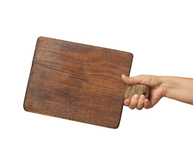 Woman holding blank brown rectangular wooden board in hand