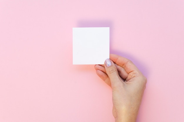 Woman holding blank paper sheet