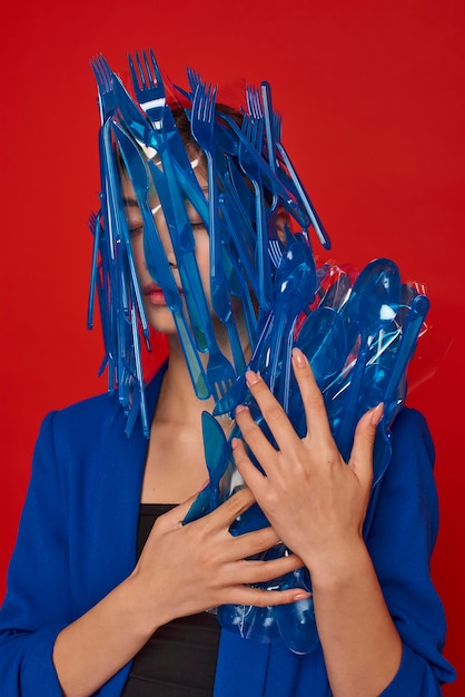 Woman holding blue plastic tableware