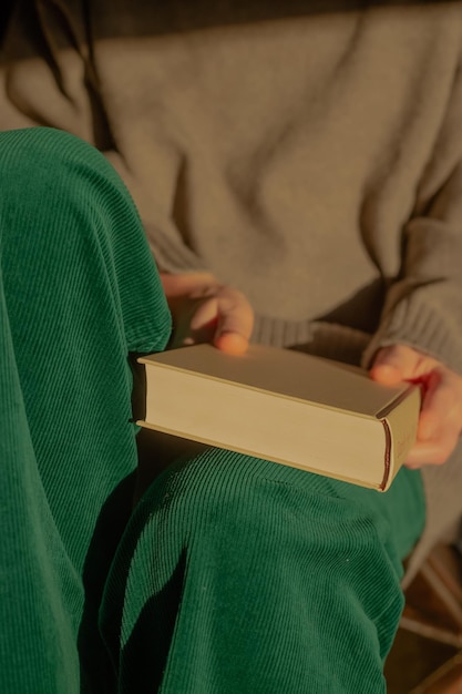 Woman holding a book in sunlight