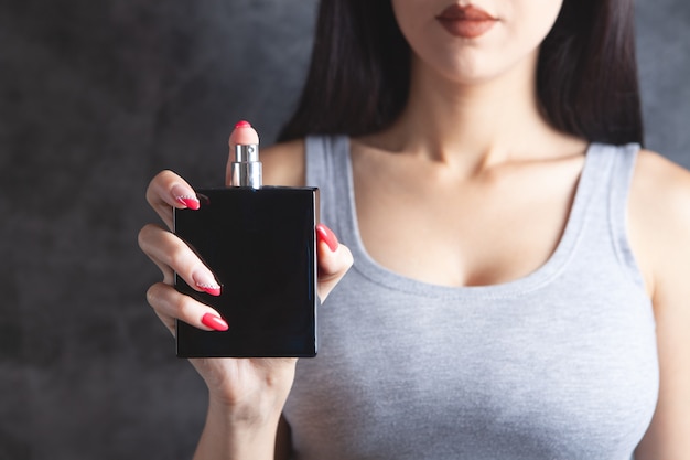 Woman holding a bottle of perfume