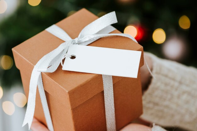 Woman holding a brown present with a white card