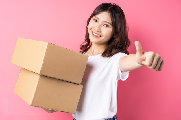 Woman holding the cargo box and smiling happily