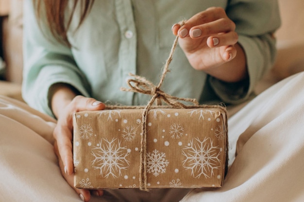 Woman holding christmas present close up photo