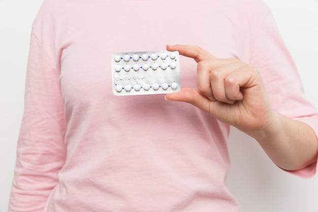 Woman holding contraceptive pills