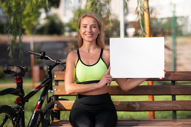 Woman holding a copy space board