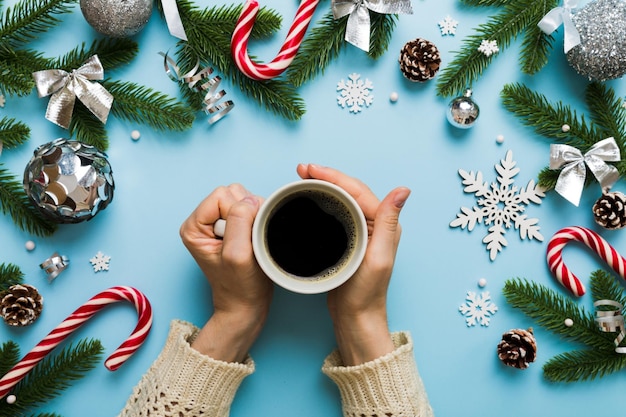 Woman holding cup of coffee Woman hands holding a mug with hot coffee Winter and Christmas time concept