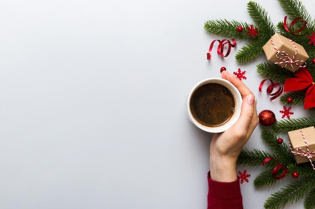 Woman holding cup of coffee Woman hands holding a mug with hot coffee Winter and Christmas time concept