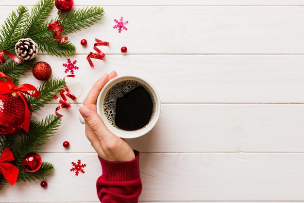 Woman holding cup of coffee Woman hands holding a mug with hot coffee Winter and Christmas time concept