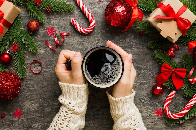 Woman holding cup of coffee Woman hands holding a mug with hot coffee Winter and Christmas time concept