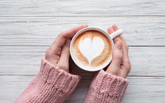 Woman holding cup of coffee