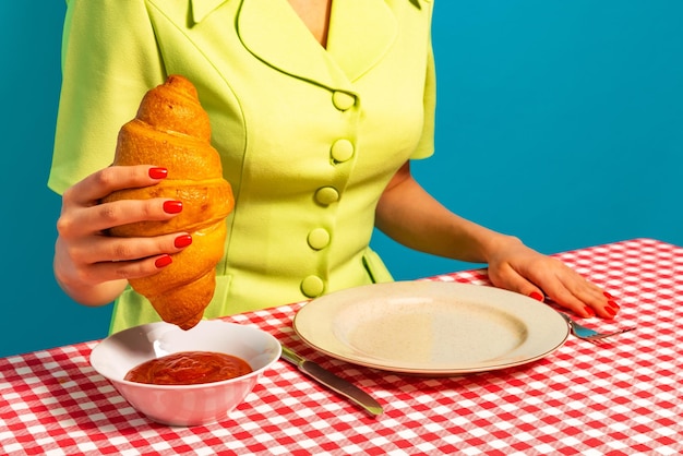 Woman holding delicious croissant eating with jam Retro style Yummy breakfast