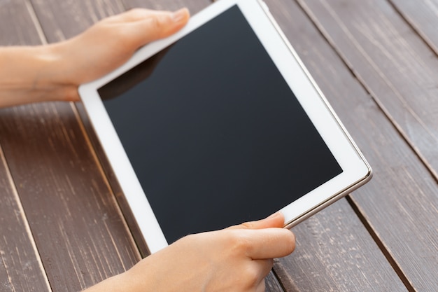 Woman holding digital tablet, closeup