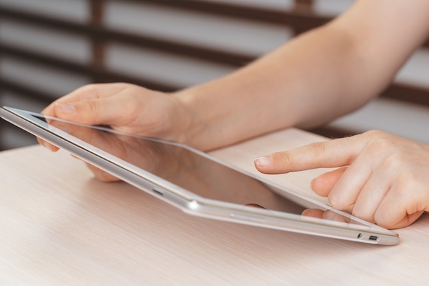 Woman holding digital tablet, closeup