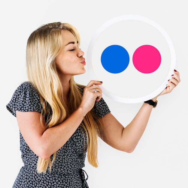 Woman holding a Flickr icon