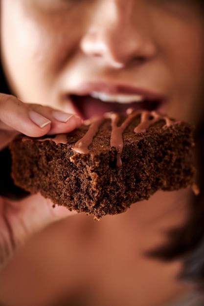 Woman holding a freshly baked homemade delicious chocolate brownie