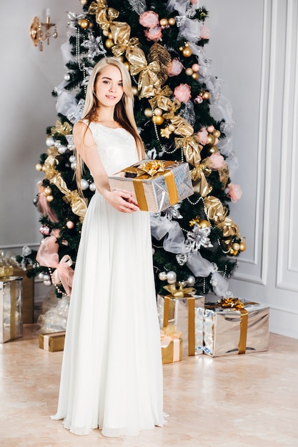 Woman holding gift box on christmas day