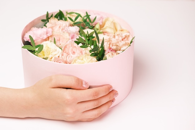 Woman holding a gift box with flowers