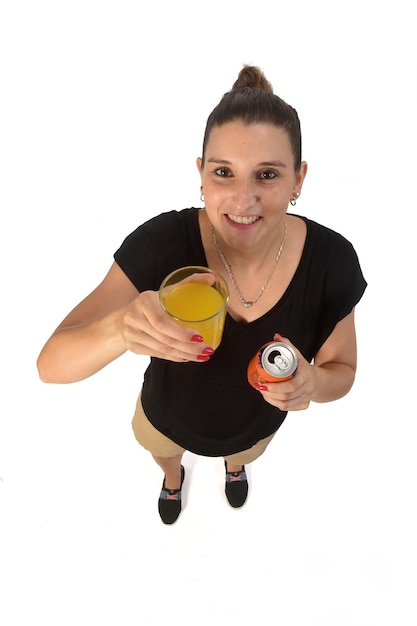 woman holding a glass of orange soda on white background