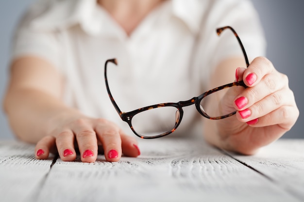 Woman holding glasses