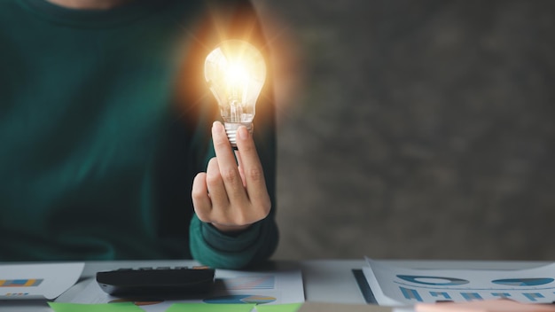 Woman holding glowing lamp Creative new idea Innovation brainstorming strategizing to make the business grow and be profitable Concept execution strategy planning and profit management