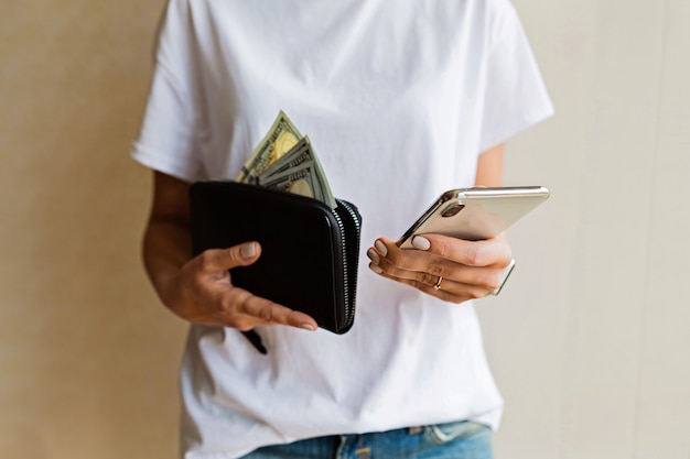 Woman holding hand wallet and mobile phone