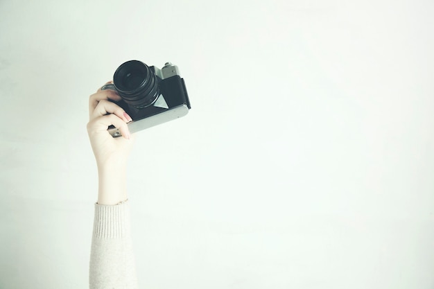 Woman holding in hands vintage camera