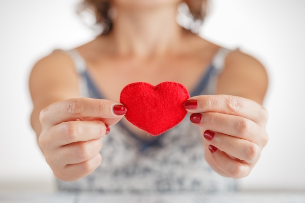 Woman holding a heart toy in her hands