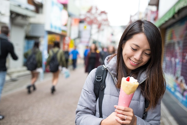 Woman holding her crepe cake at Tokyo city