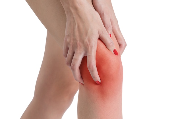 Woman holding her knee with red highlight in pain area- isolated on white background.