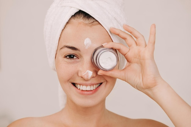 Woman holding jar of face cream