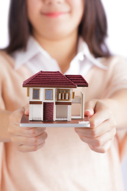 Woman holding little house