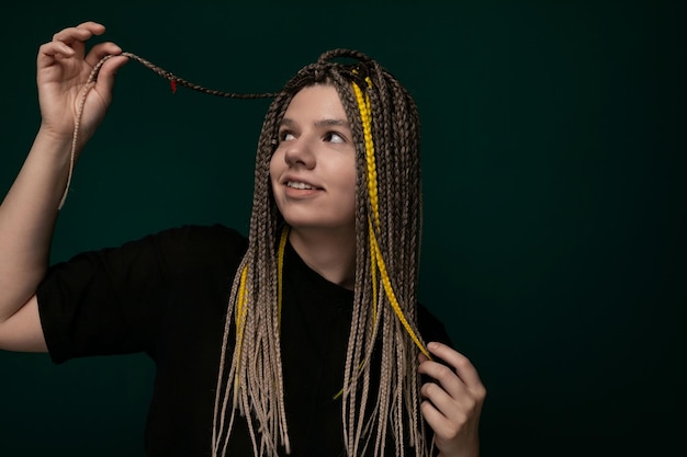 Woman holding long dreadlocks in the air