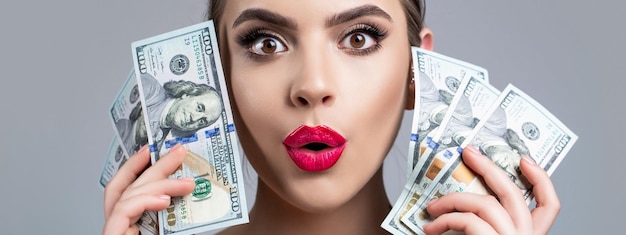 Woman holding lots of money in dollar currency Luxury beauty and money concept Woman with dollars in hand Portrait woman holding money banknotes Girl holding cash money in dollar banknotes