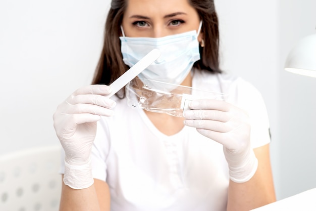 Woman holding medical tool.