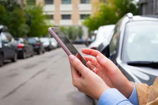 Woman holding mobile phone and booking cab