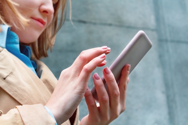 Woman holding mobile phone in hand