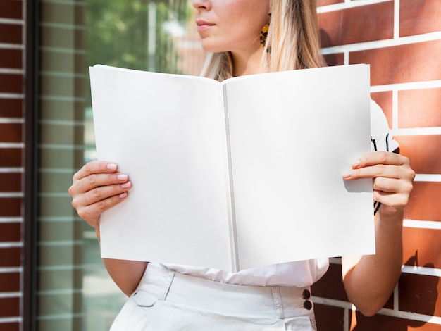 Woman holding a mock-up magazine