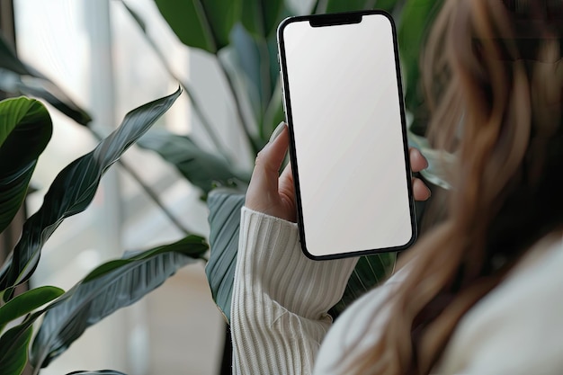 Photo woman holding modern smartphone mockup