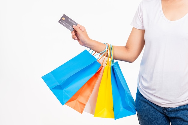 Woman holding multicolor shopping bags and credit card