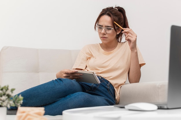 Woman holding notebook and thinking