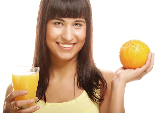 Woman holding orange and juice