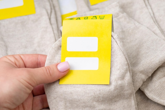 Woman holding pair of new socks with label reading information about it