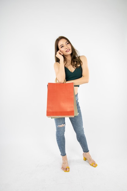 Woman holding paper bags on white background