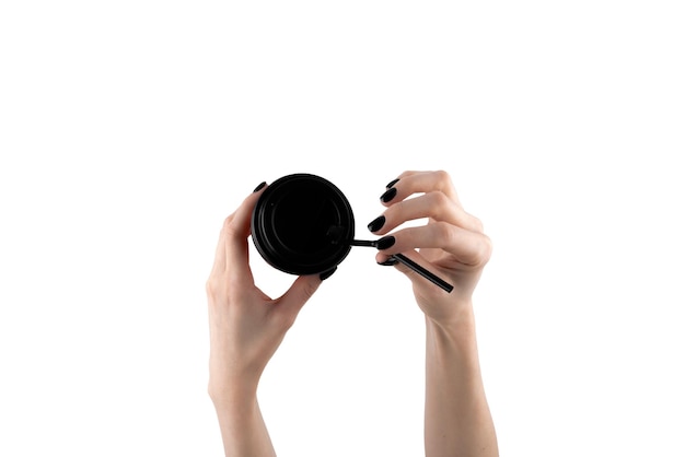 Woman holding paper cup of hot coffee with white background Female hand with black nails