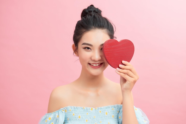 Woman holding paper heart shaped card Valentine day concept