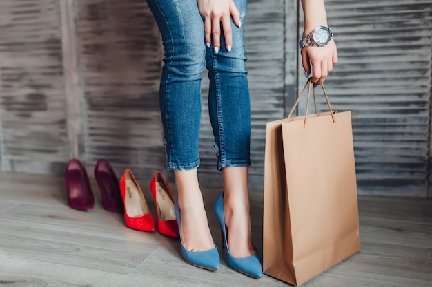 Woman holding paper package after shopping time.