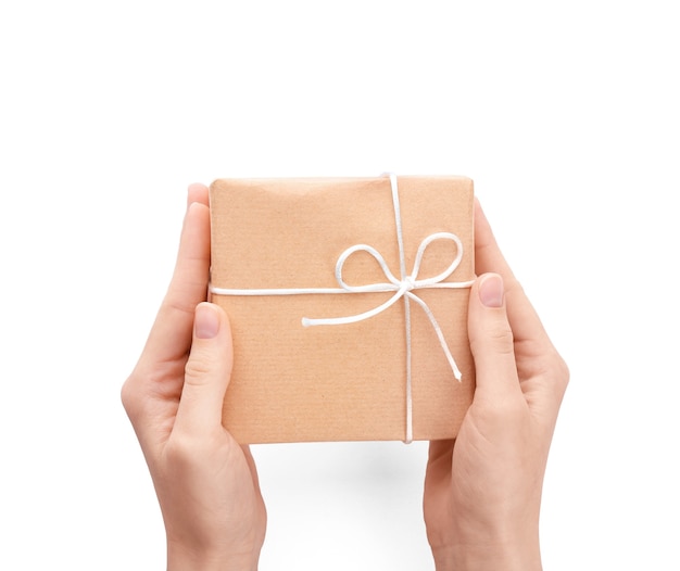 Woman holding parcel gift box on white background, top view