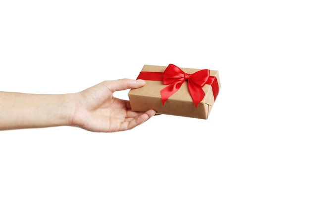 Woman holding parcel wrapped in kraft paper on white background, closeup